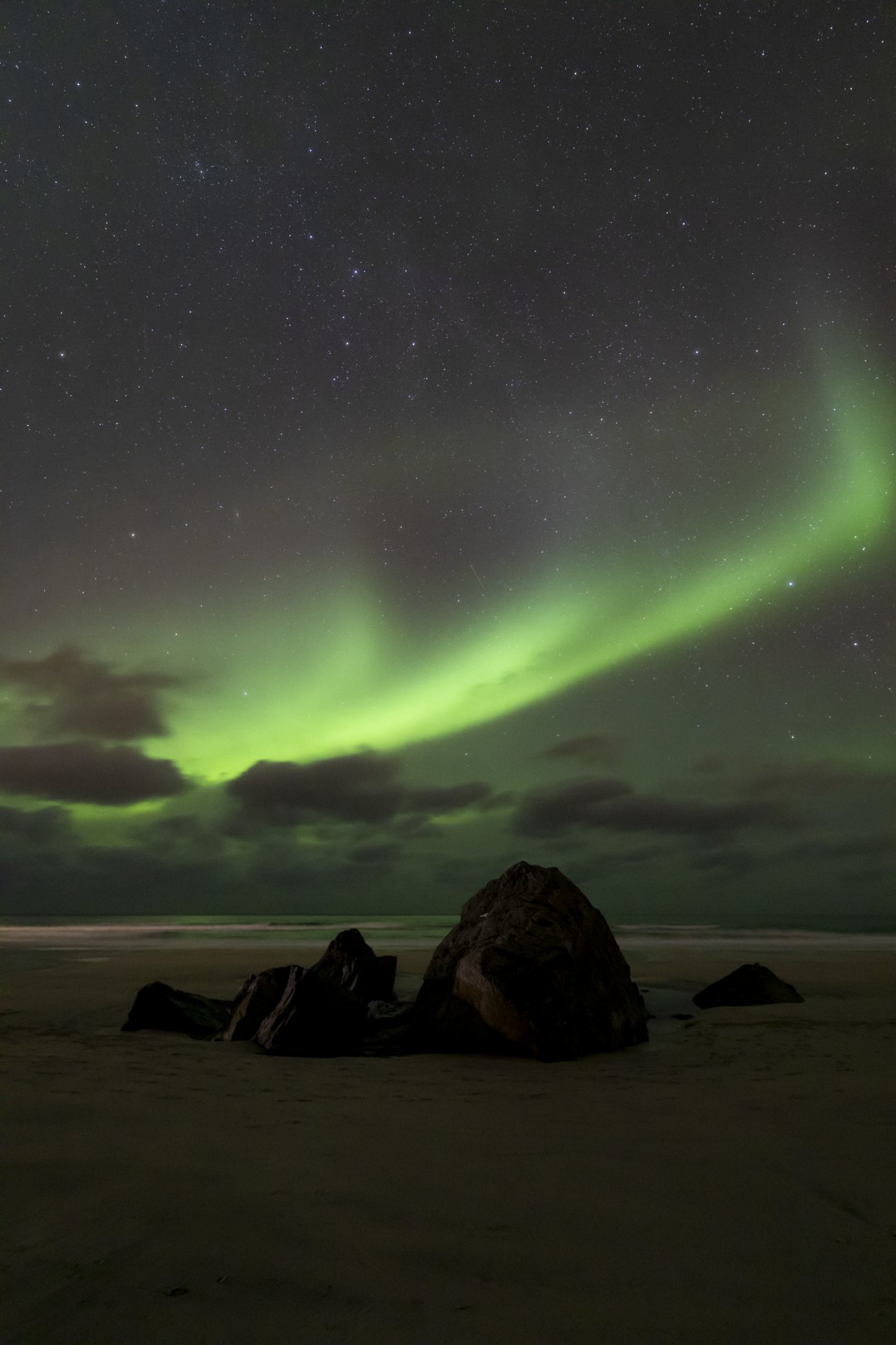 Aurora borealis over the Atlantic under a starry sky, atmospheric phenomena in the high atmosphere